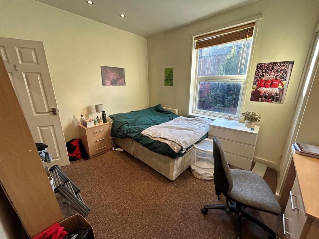 A spacious and bright master bedroom featuring ...