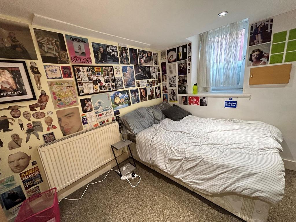 A tidy and cozy bedroom featuring a comfortable...