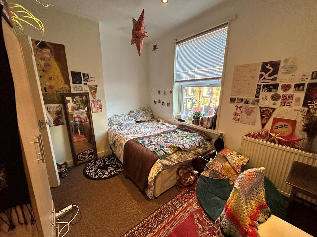 A cozy double bedroom with natural light stream...