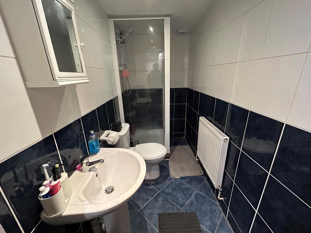 A modern bathroom featuring a shower enclosure,...