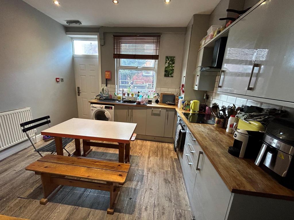 A modern and well-lit kitchen featuring a clean...