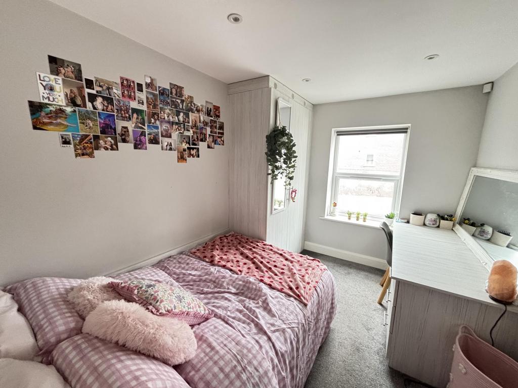 A bright and inviting bedroom featuring a cozy ...