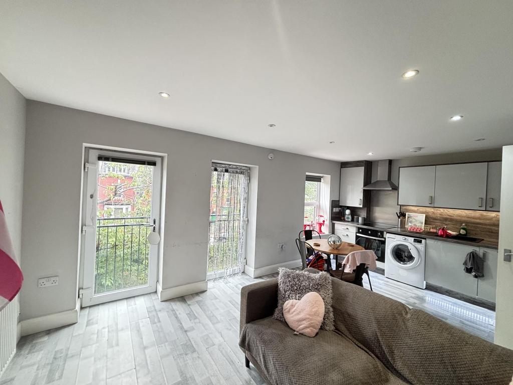 A bright and spacious living room featuring lar...