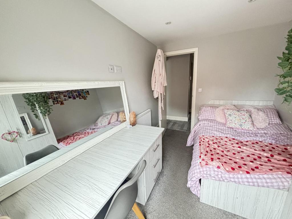 A bright and welcoming bedroom featuring a doub...