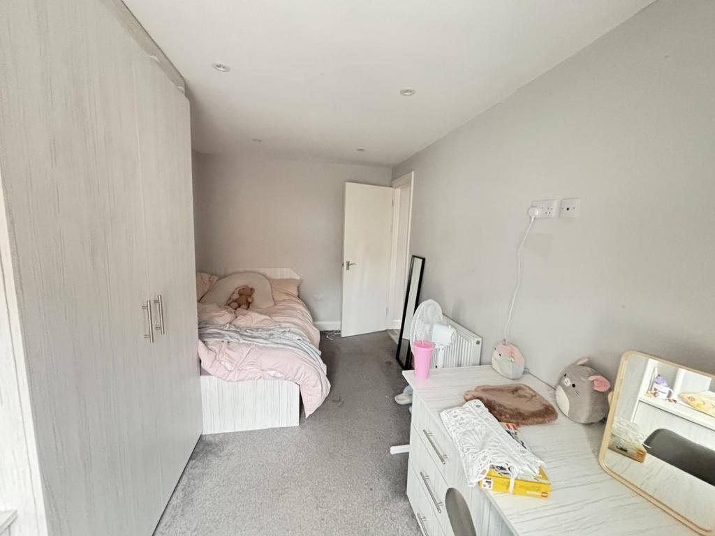 A spacious and inviting bedroom featuring a dou...