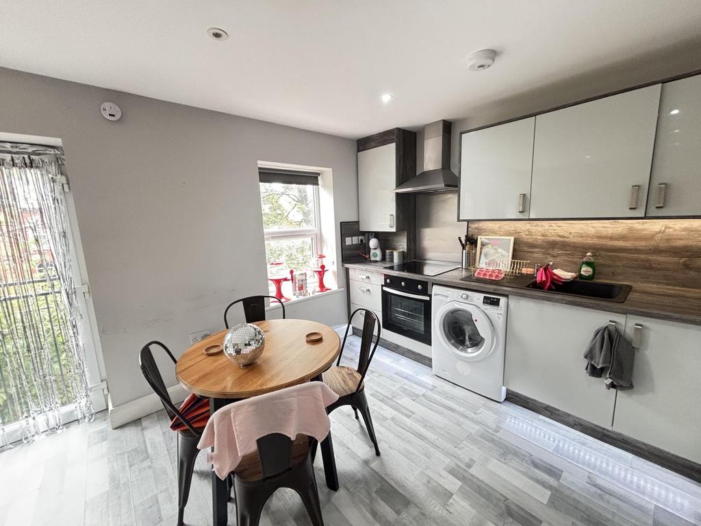 A modern, well-lit kitchen featuring ample work...