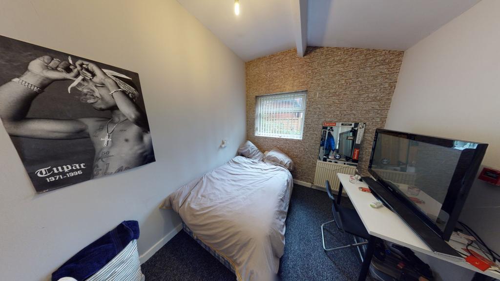 A cozy, tidy bedroom featuring a comfortable si...