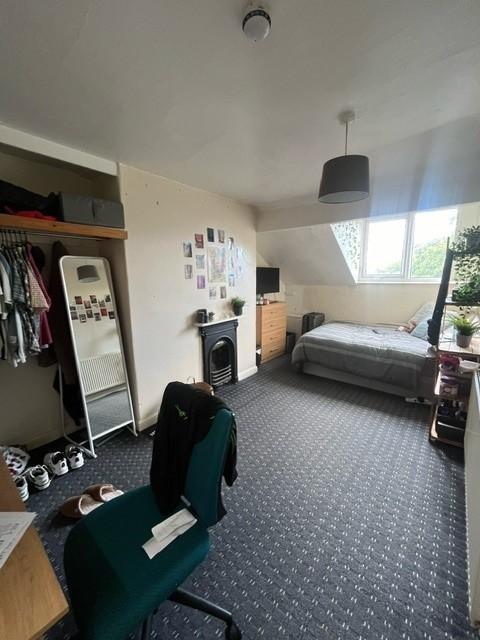 A spacious and well-lit living room featuring a...