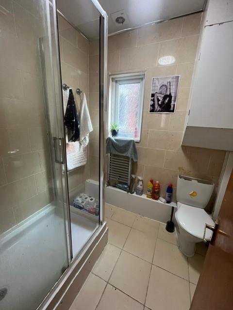 A well-maintained bathroom featuring a shower c...