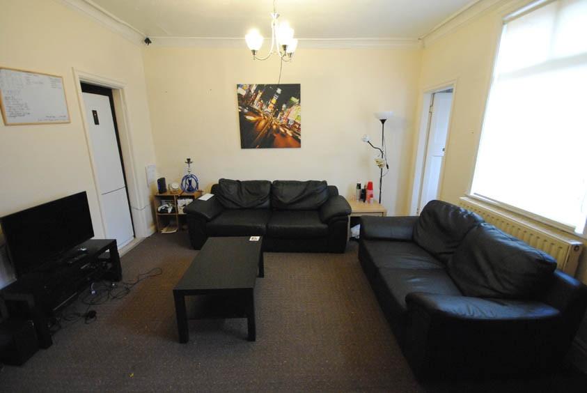 A well-lit, spacious living room featuring two ...