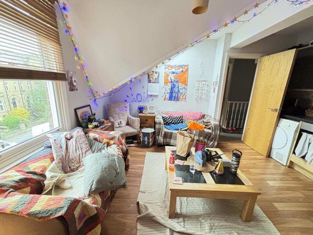 A bright and cozy living room featuring comfort...