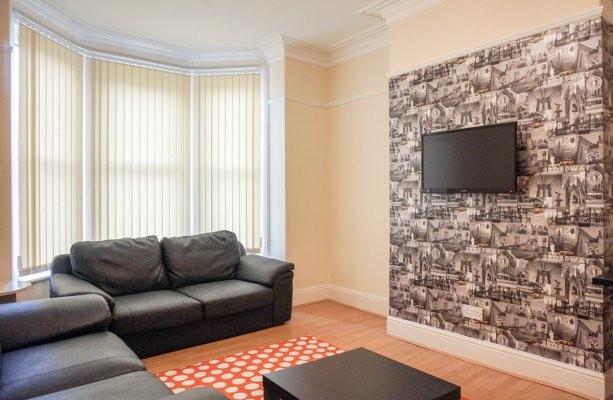 A bright and inviting living room featuring com...