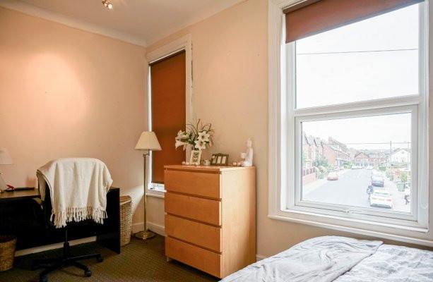 A cozy bedroom featuring a large window that al...