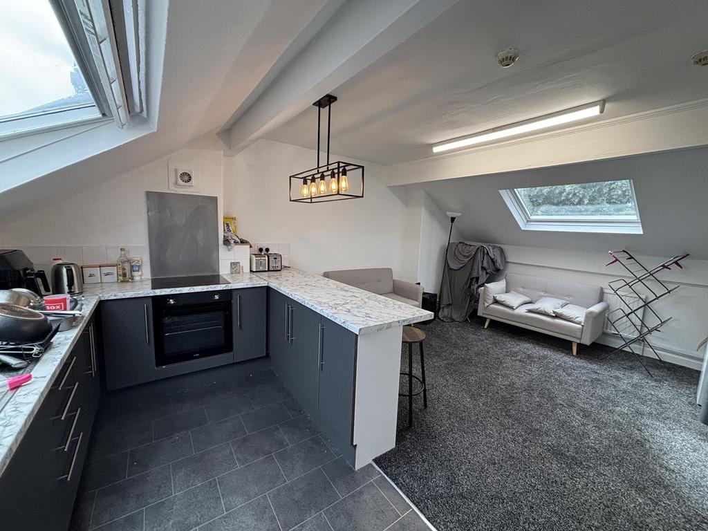 A modern, well-lit kitchen area with spacious c...