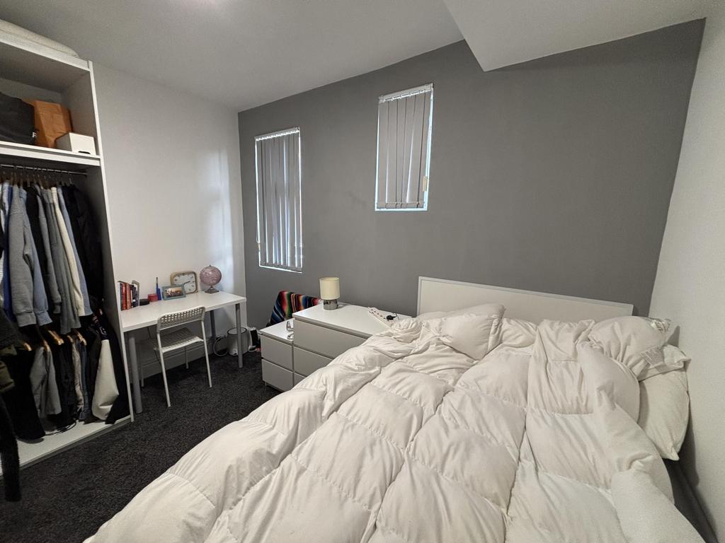 A bright and spacious master bedroom featuring ...