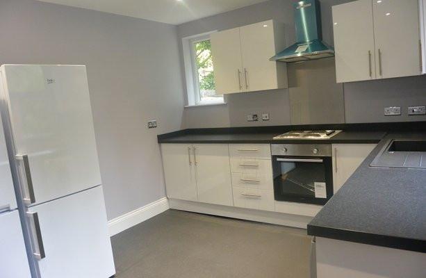 A modern, bright kitchen with fresh white cabin...