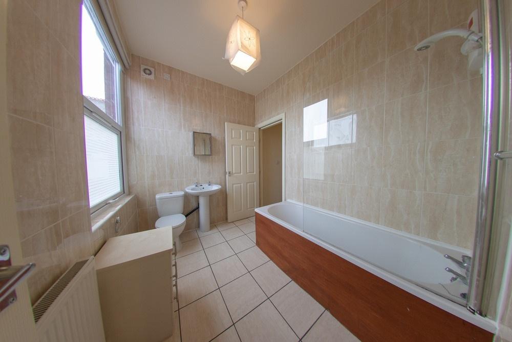 A spacious, well-maintained bathroom with a lar...