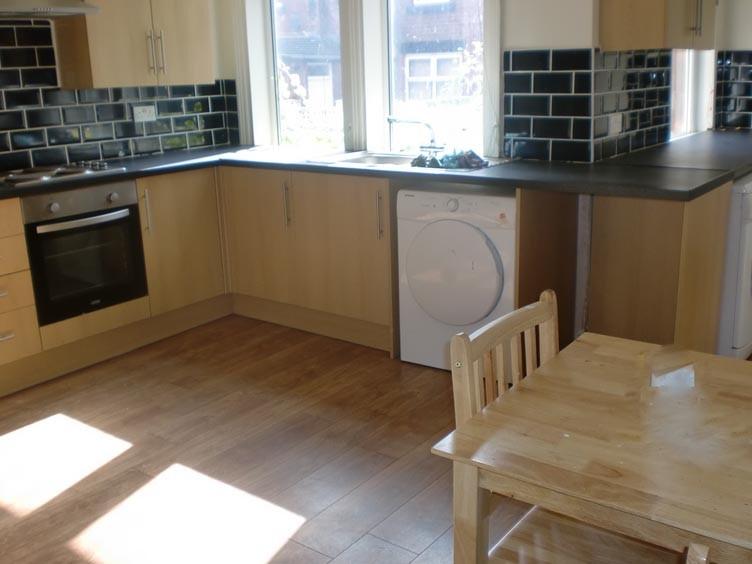 A bright and tidy kitchen area featuring modern...