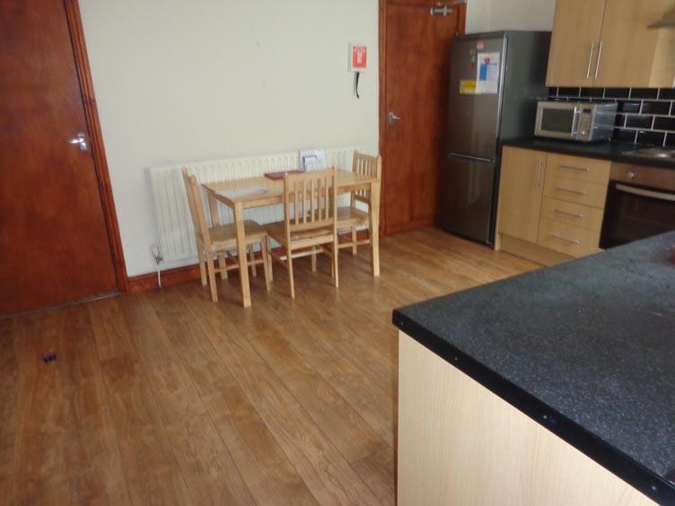 A functional kitchen area featuring wooden cabi...