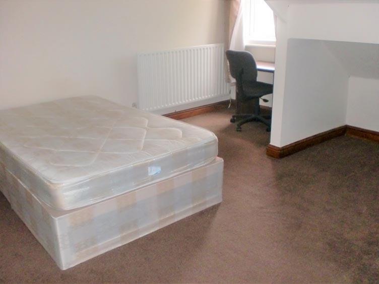 A tidy bedroom featuring a new double bed, with...
