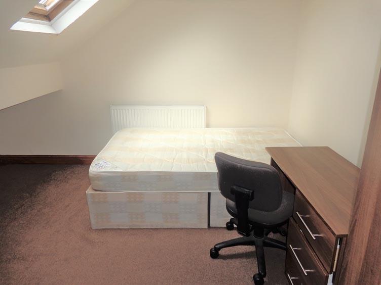 A bright and tidy living room featuring ample n...