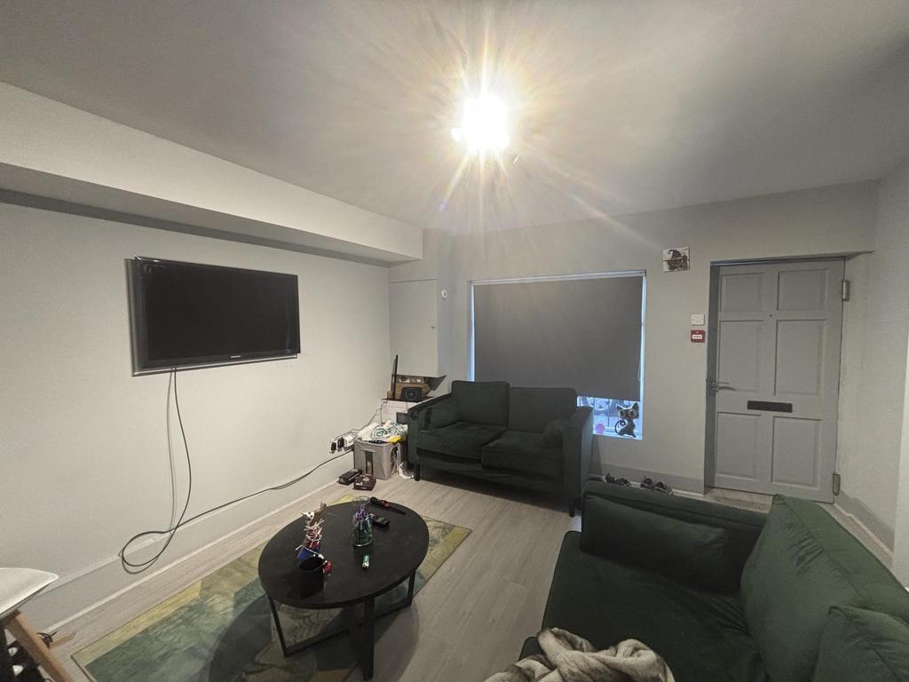 A modern, well-lit living room with comfortable...