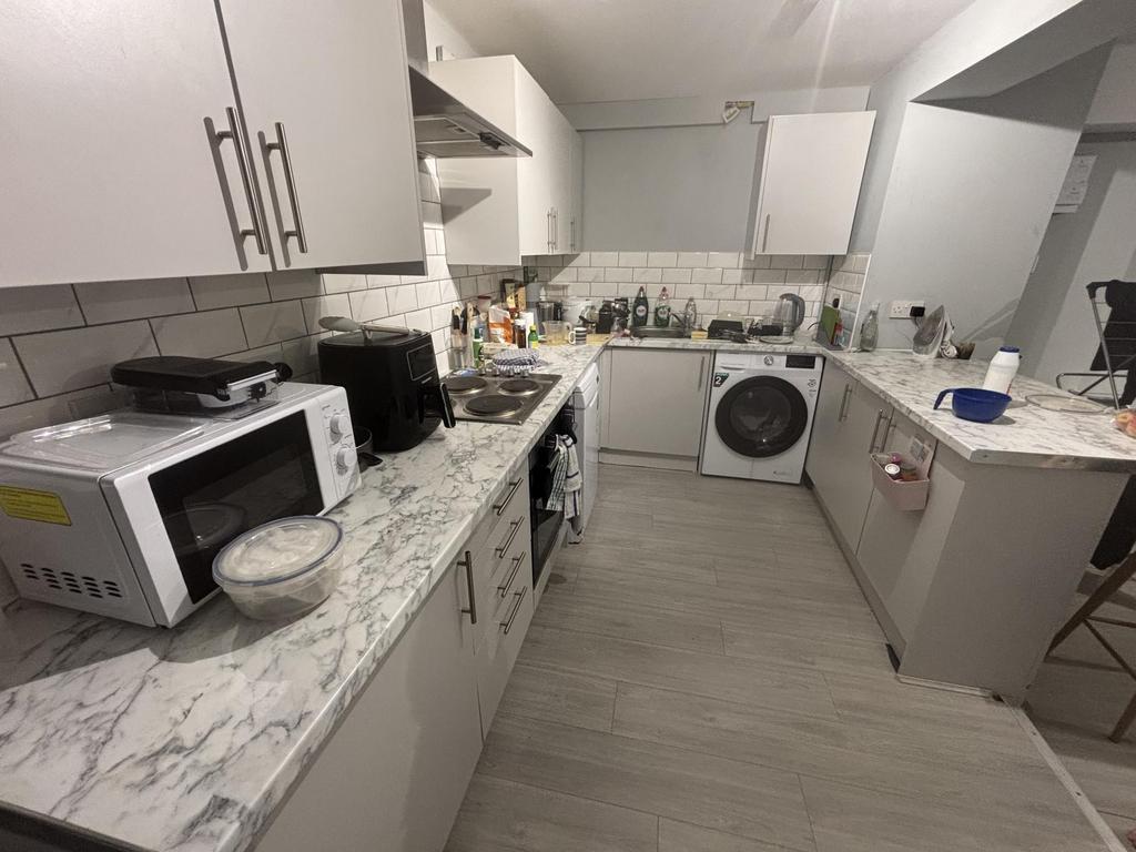 A well-maintained modern kitchen with ample wor...