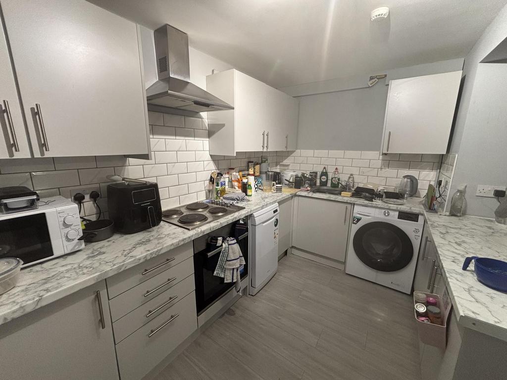 A modern, well-lit kitchen featuring ample coun...