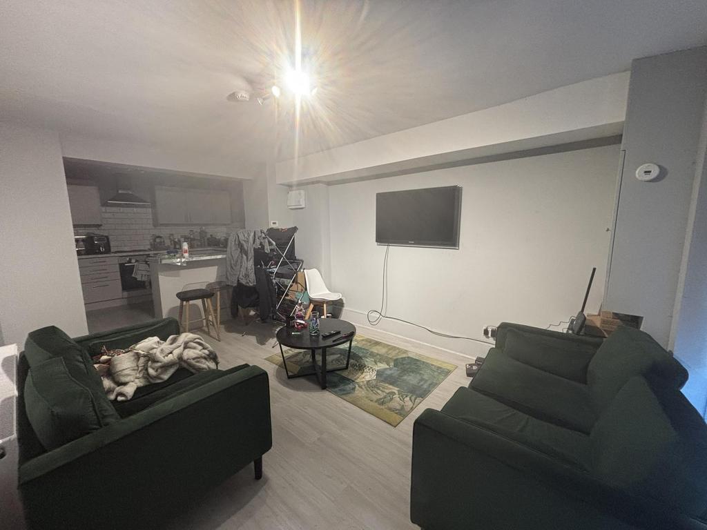 A cozy living room featuring comfortable sofas,...