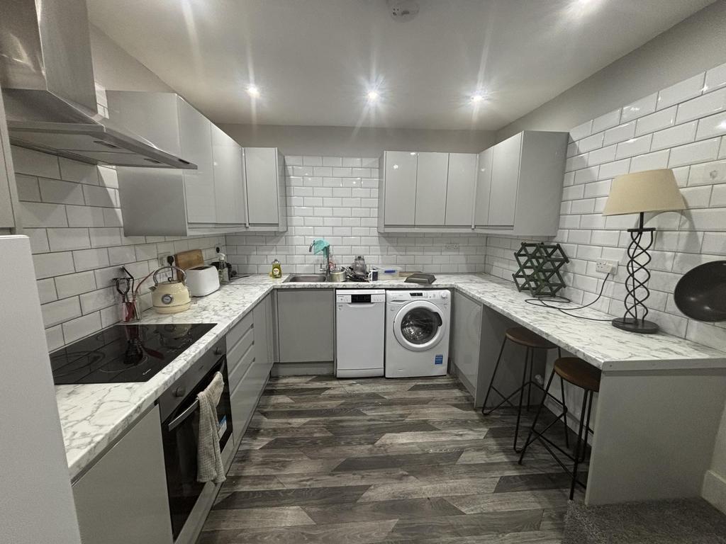 A clean and modern kitchen with ample counter s...