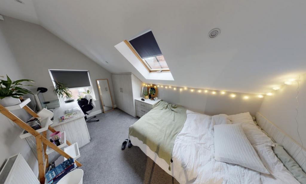 Bright and cozy bedroom with ample natural ligh...