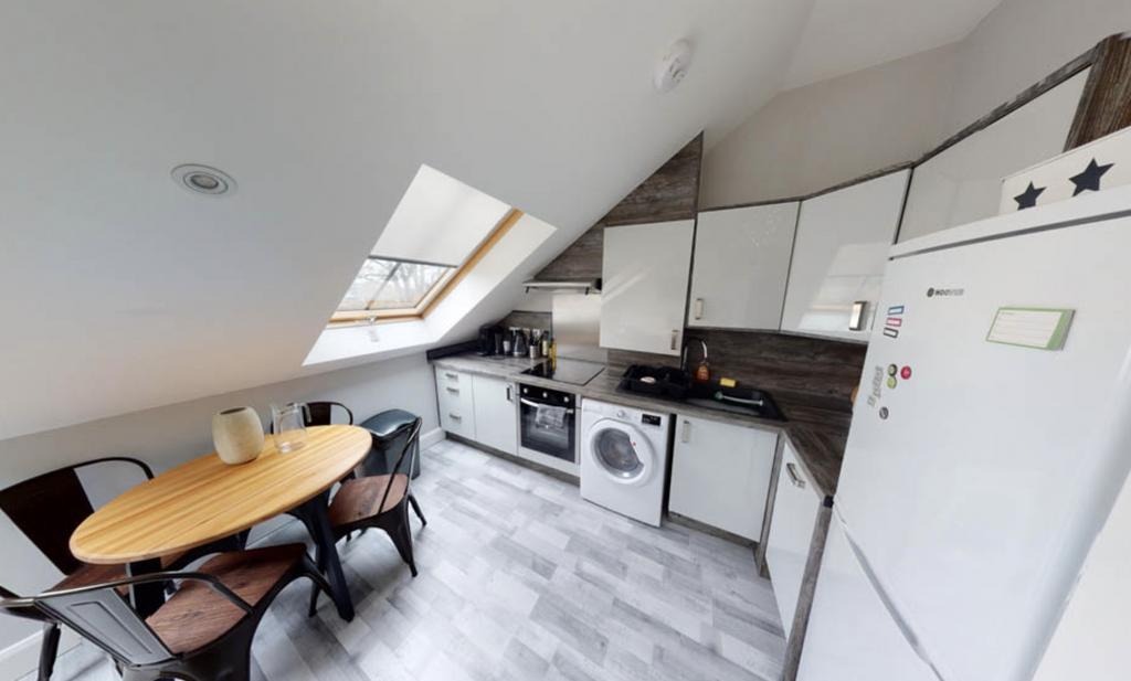 Modern kitchen space with ample natural light, ...