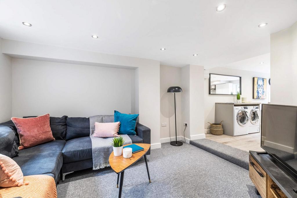 Bright and spacious living room featuring comfo...