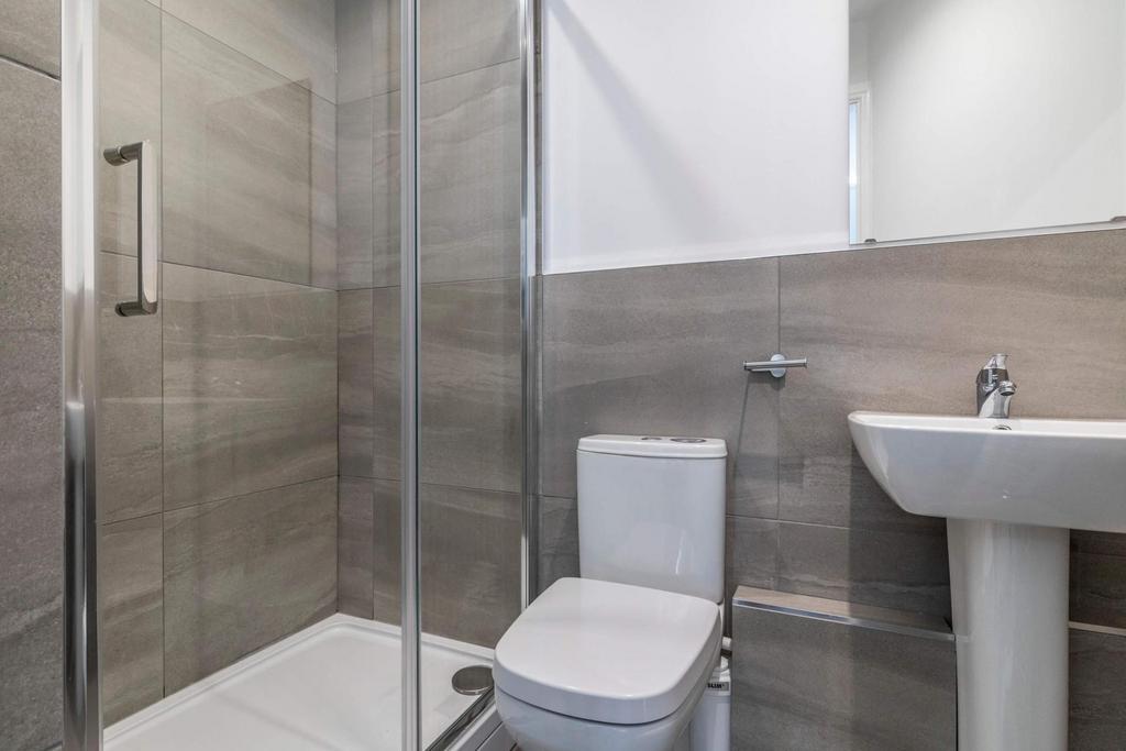 Clean and modern bathroom with a spacious showe...