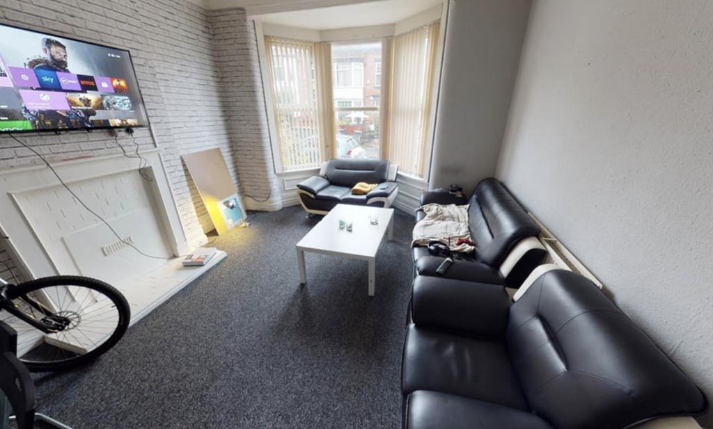 A modern, well-lit living room with a comfortab...