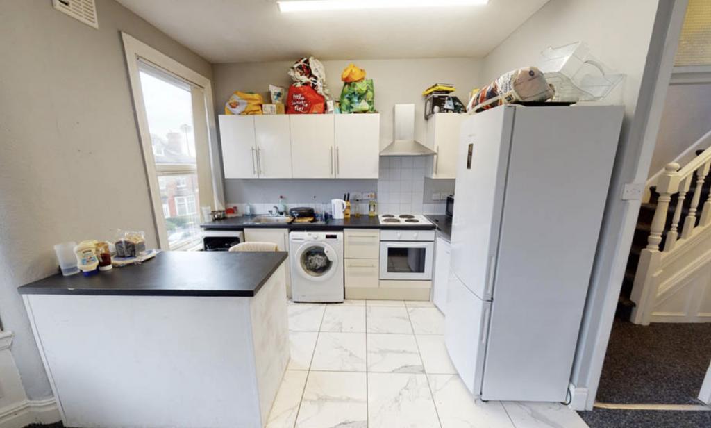 A bright and clean kitchen with white cabinets ...
