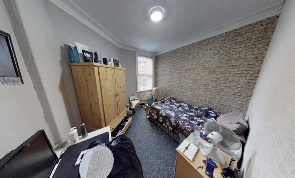 A well-maintained bedroom featuring a double be...