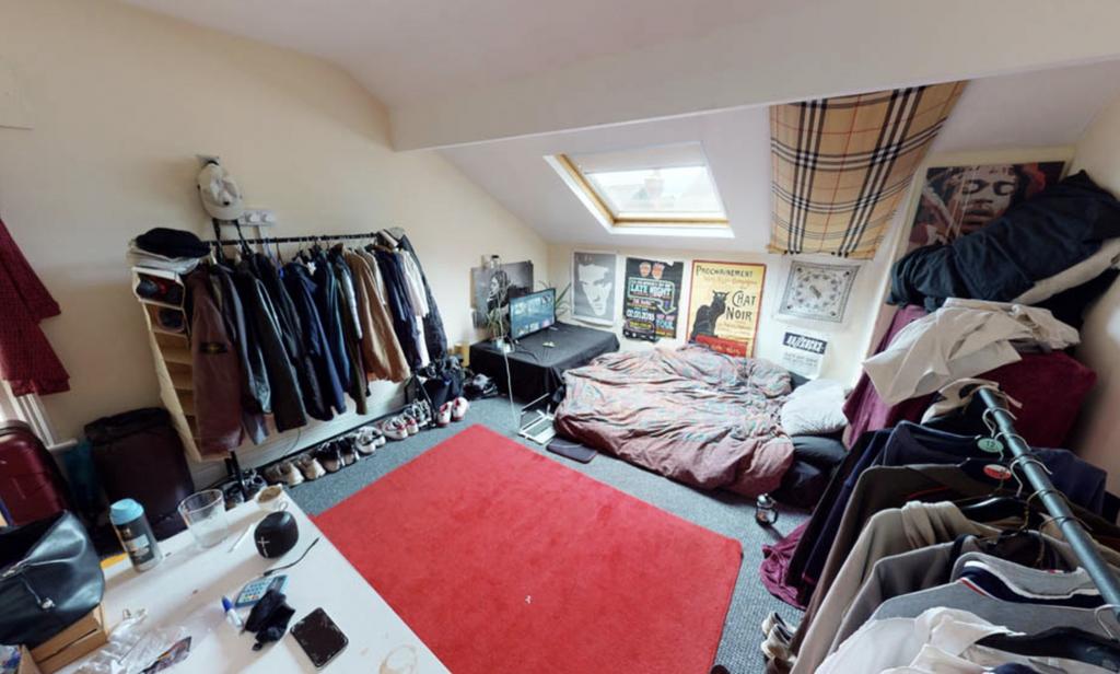 A cozy bedroom with a large window providing na...