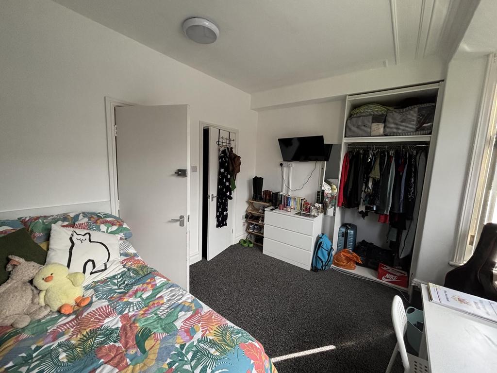A cozy bedroom featuring a bed with a colorful ...