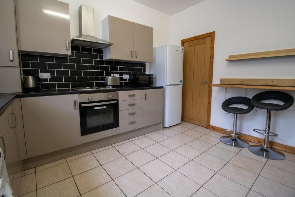 Modern fitted kitchen with neutral cabinetry, i...