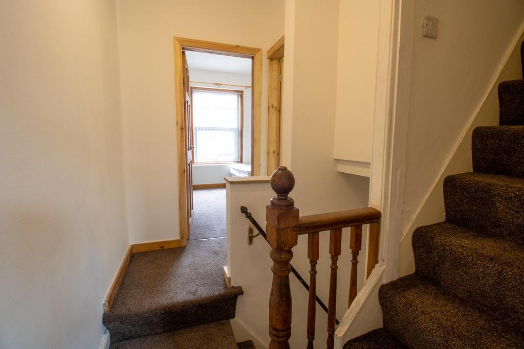 Bright entrance hallway with carpeted stairs an...