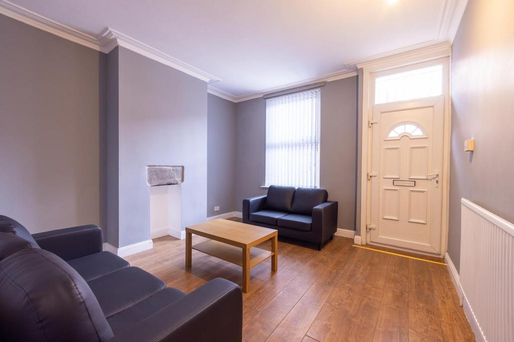 Bright, simply furnished living room with two s...