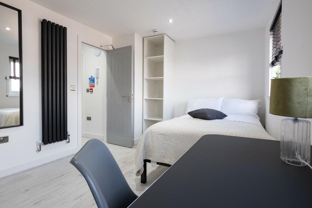 A bright and tidy double bedroom featuring a co...