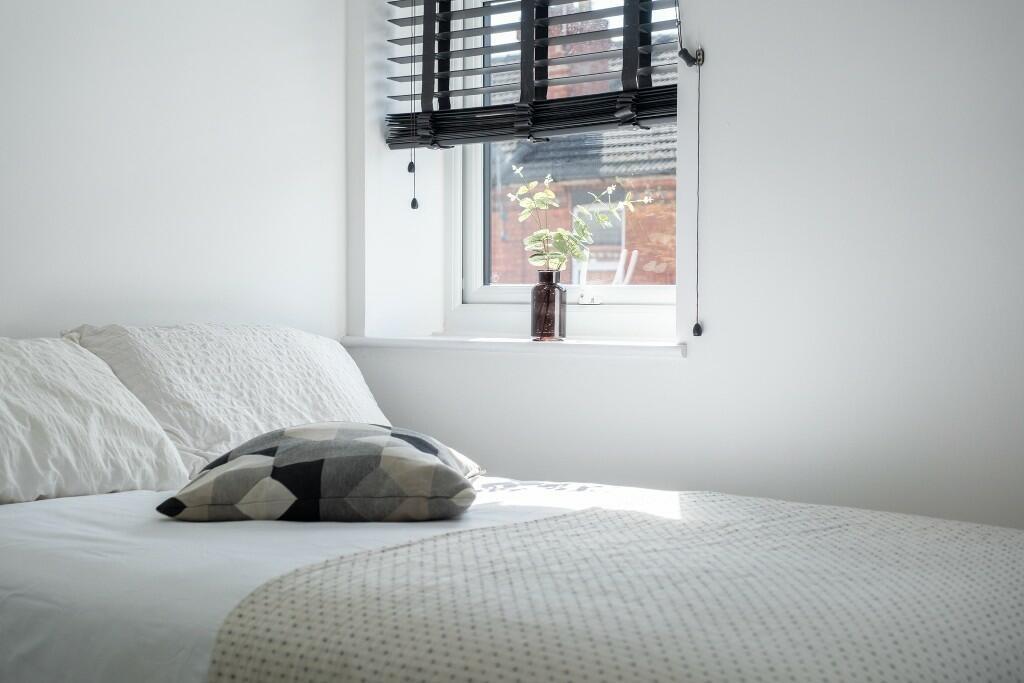 Bright and cozy double bedroom featuring a fres...