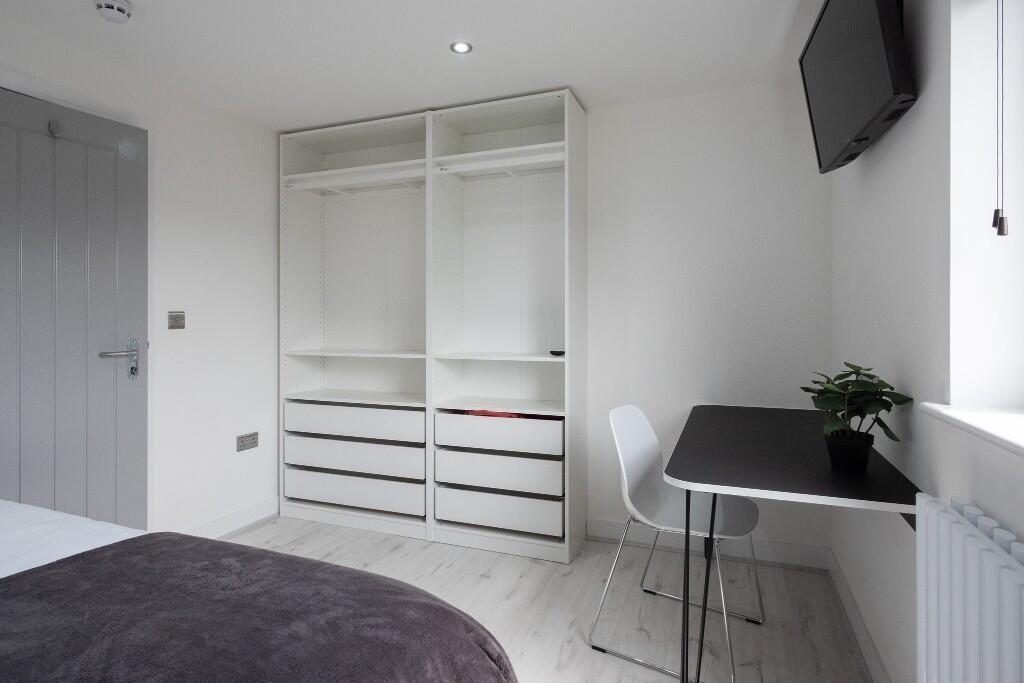 A modern single bedroom featuring a minimalist ...