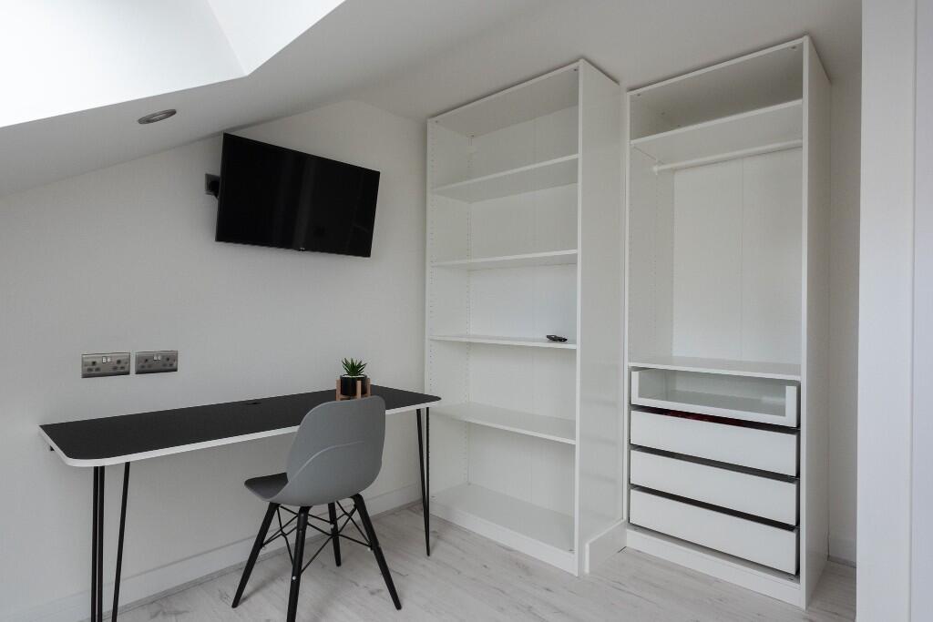 A bright and modern communal workspace featurin...
