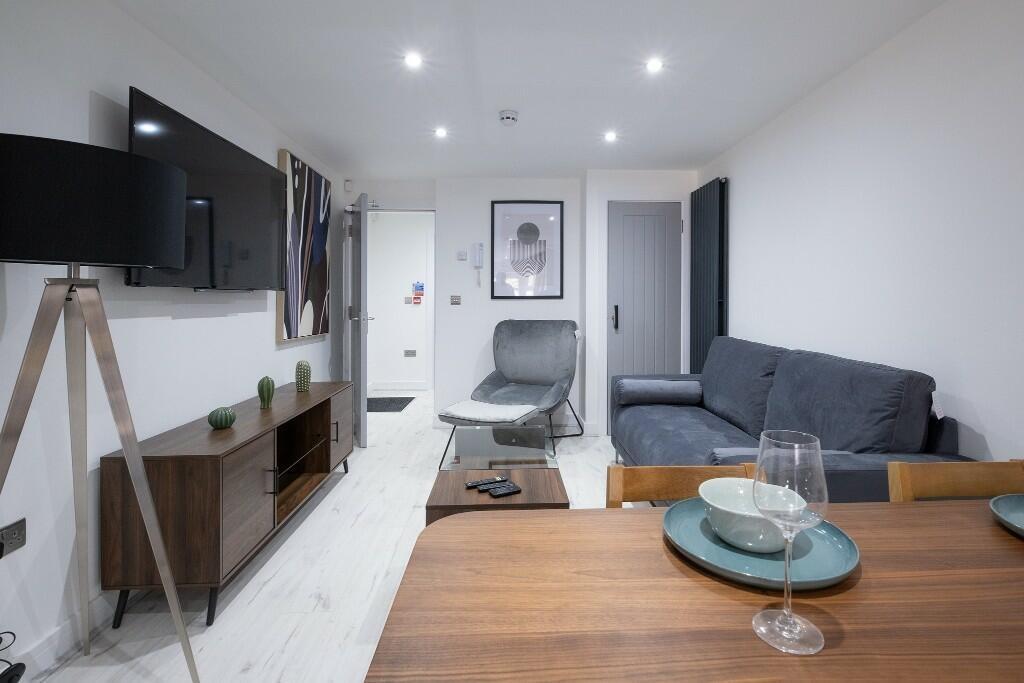 Contemporary living room with modern seating, a...