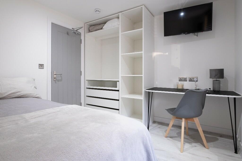 Bright, modern furnished bedroom with built-in ...