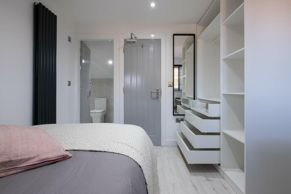 Bright, modern double bedroom with a comfortabl...