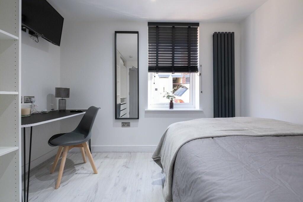 Bright, modern bedroom with a comfortable doubl...